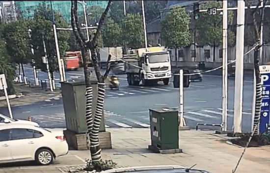 Scooterist squished when cutting in front and run over by a dump truck.mp4.gif