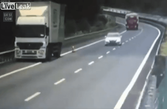 Truck driver drifts and crashes into a stalled truck.gif