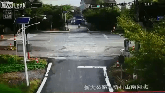 Scooterist runs a red light and struck and run over by a car.gif